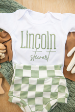 Load image into Gallery viewer, Baby outfit with 'Lincoln Stewart' on a white onesie and green checkered pants.