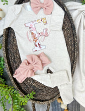 Load image into Gallery viewer, Baby clothing set with onesie, blanket, and headbands on a wooden surface with greenery.

