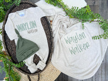 Load image into Gallery viewer, Baby outfit with &#39;Waylon Walker&#39; printed on a onesie and t-shirt, surrounded by greenery.
