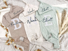 Load image into Gallery viewer, Three baby rompers with embroidered names on a textured surface.
